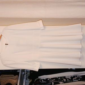 White 3/4 sleeved dress with gold button details.